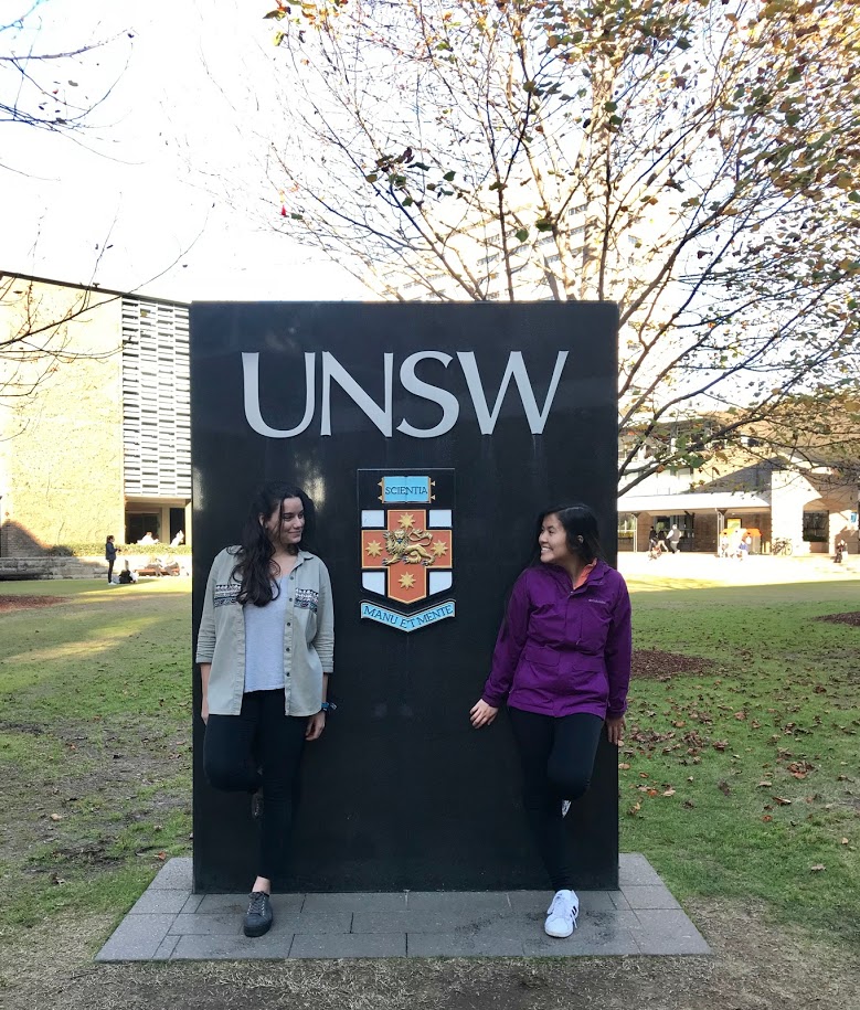 University of New South Wales Sign with two students in front