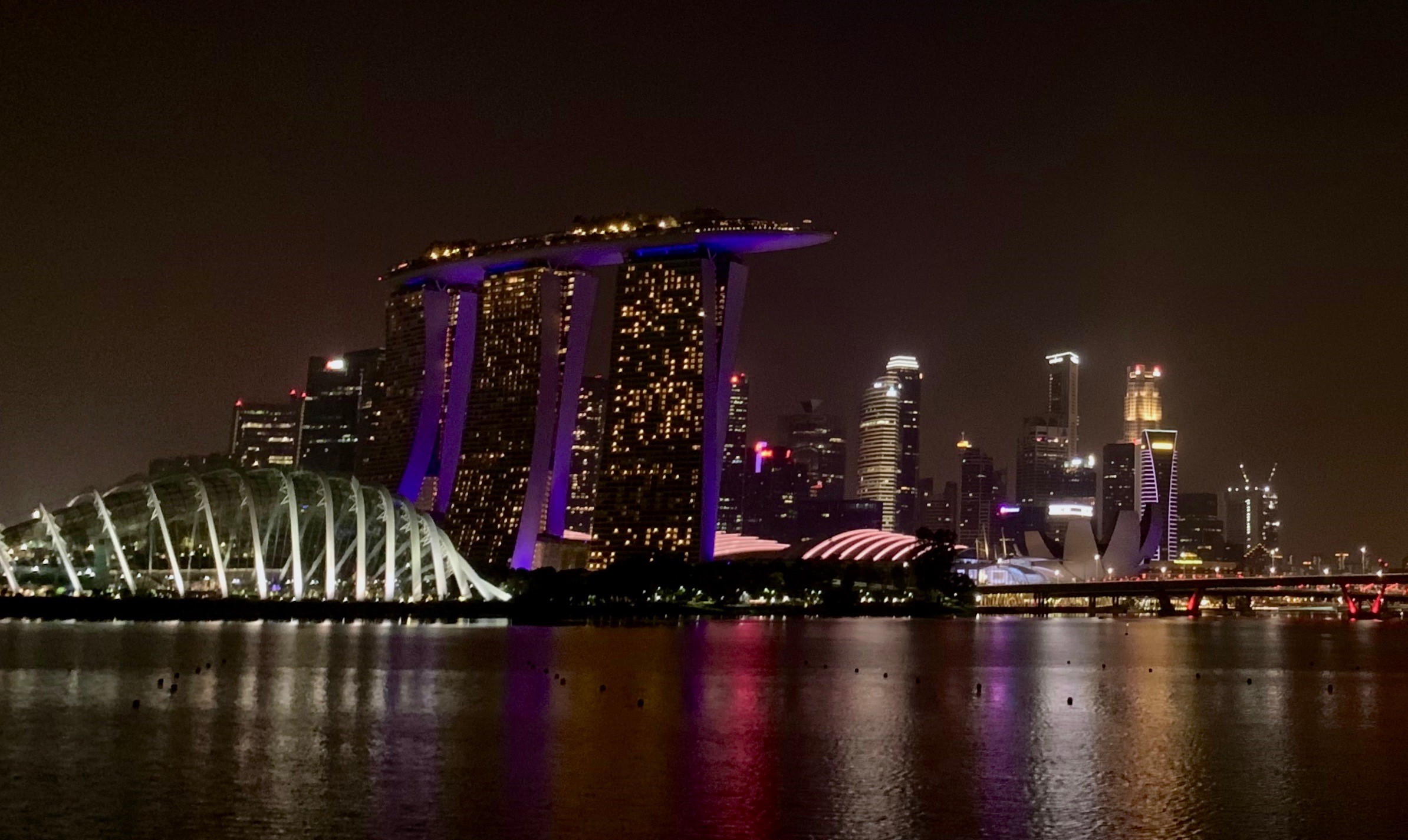 Singapore skyline at night, by the water.