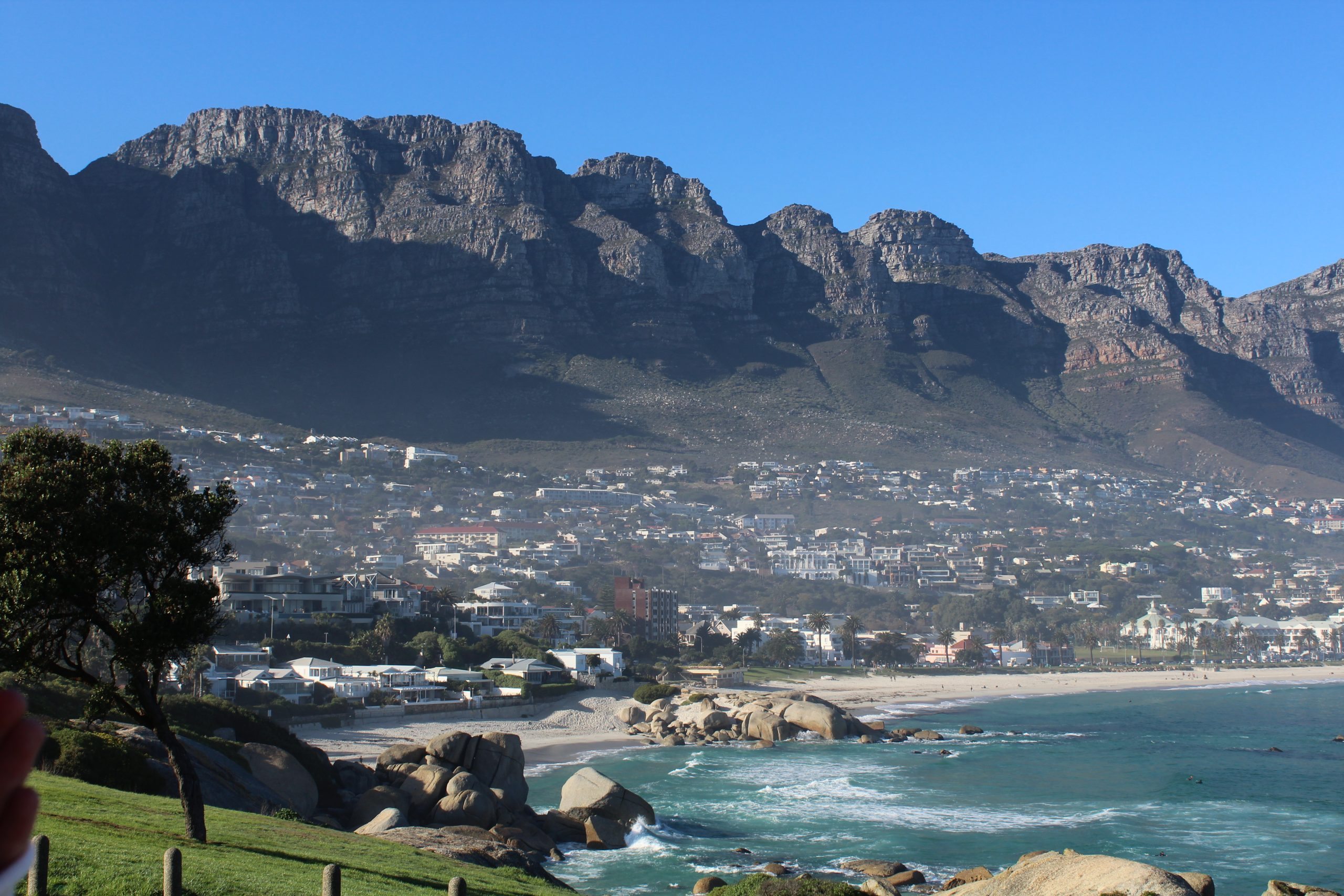 Mountain with a city below it. The village is by the ocean in South Africa.