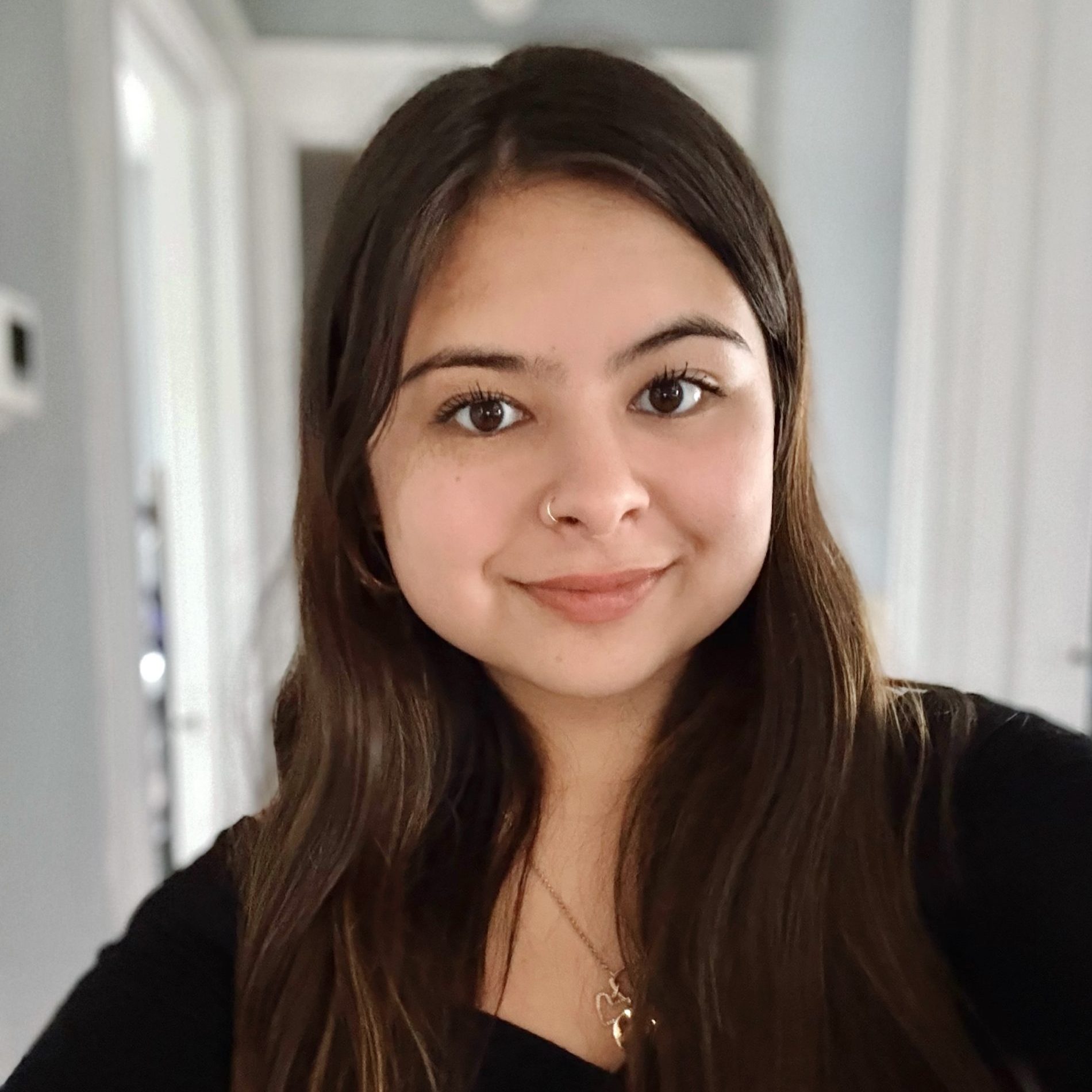 Female student headshot with shoulder length brown hair wearing a black long sleeve shirt.
