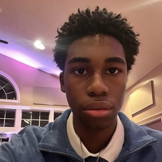 Male students wearing a collared shirt and a quarter zip.